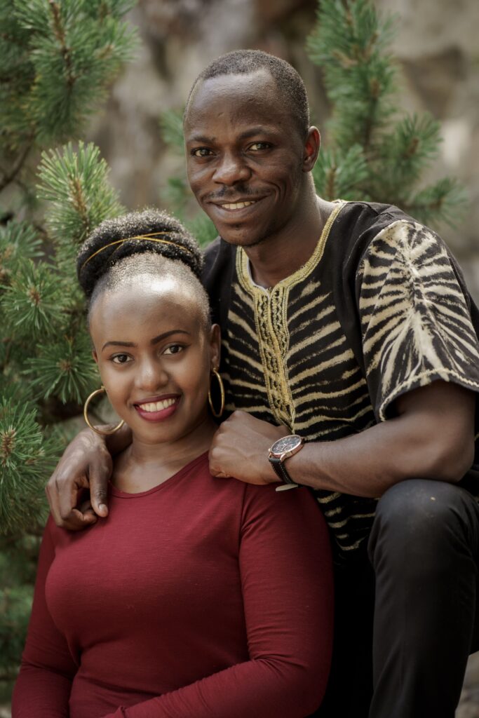 A smiling couple posing together outdoors.